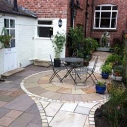 Back yard paved with circular feature